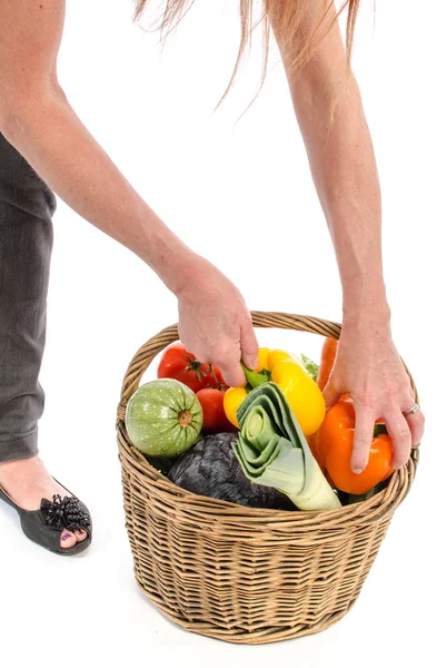 Woman with a basket full of vegetables — Stock Photo, Image