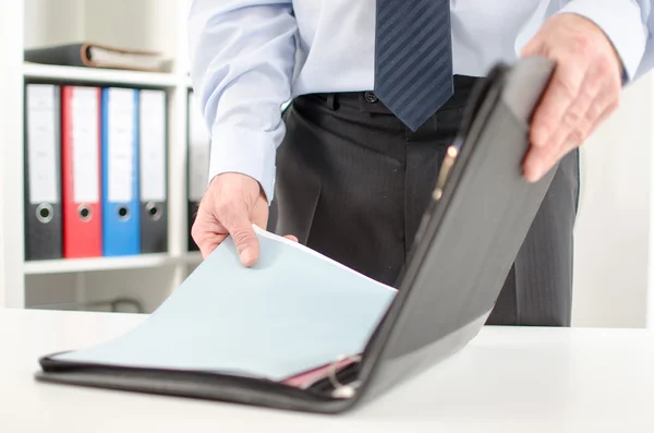 Businessman taking folder from his briefcase — Stock Photo, Image
