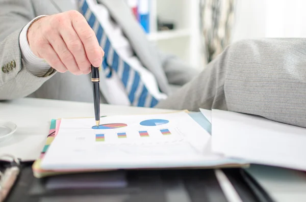 Relaxed businessman checking financial graphs — Stock Photo, Image