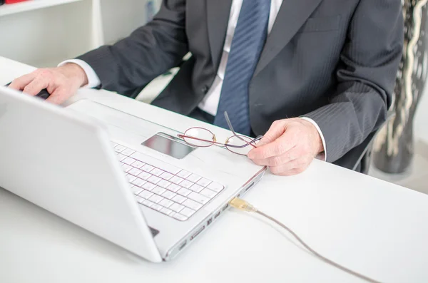 Businessman sitting in front of his laptop — Stock Photo, Image