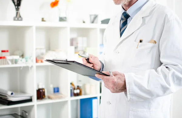 Doctor checking his notes — Stock Photo, Image