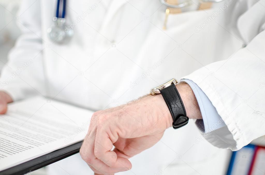 Doctor looking at his watch