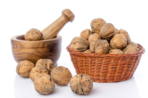 Walnuts in a basket and a wooden mortar — Stock Photo, Image