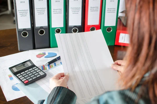 Female accountant checking financial documents — Stock Photo, Image