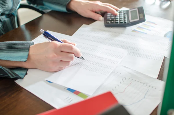 Female accountant checking financial documents — Stock Photo, Image