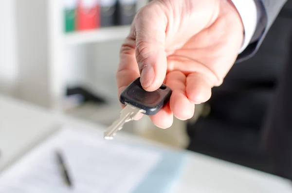 Salesman holding car key — Stock Photo, Image