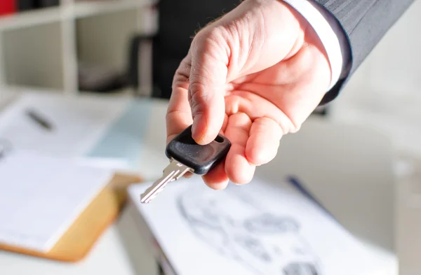 Salesman holding car key — Stock Photo, Image