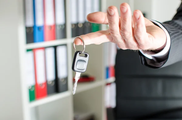 Salesman holding a key — Stock Photo, Image