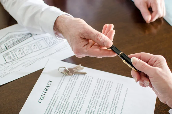 Agent immobilier donnant un stylo pour signature — Photo