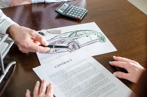 Dealer showing a detail on a car design — Stock Photo, Image