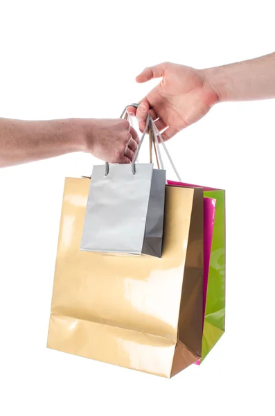 Mão dando sacos de compras — Fotografia de Stock