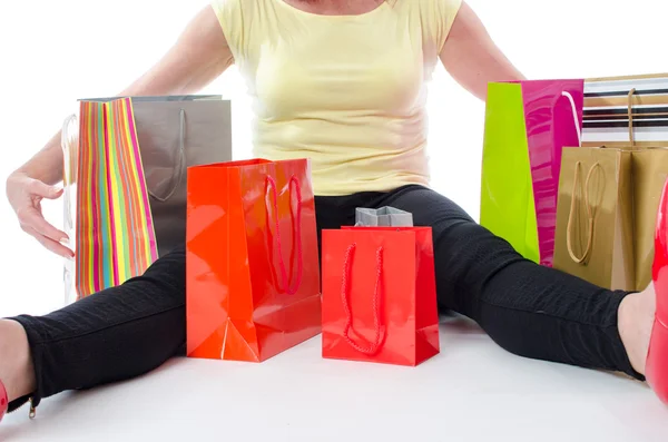 Woman sitting in the middle of shopping bags — Stock Photo, Image