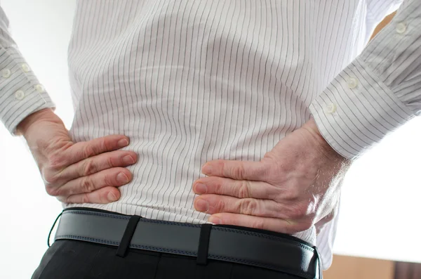 Hombre de negocios con dolor de espalda —  Fotos de Stock