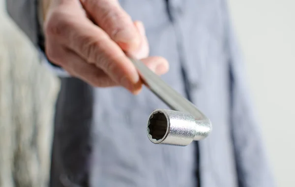 Hand holding a socket wrench — Stock Photo, Image