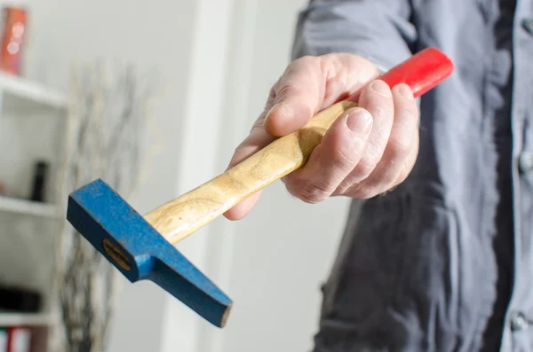 Hand holding a hammer — Stock Photo, Image