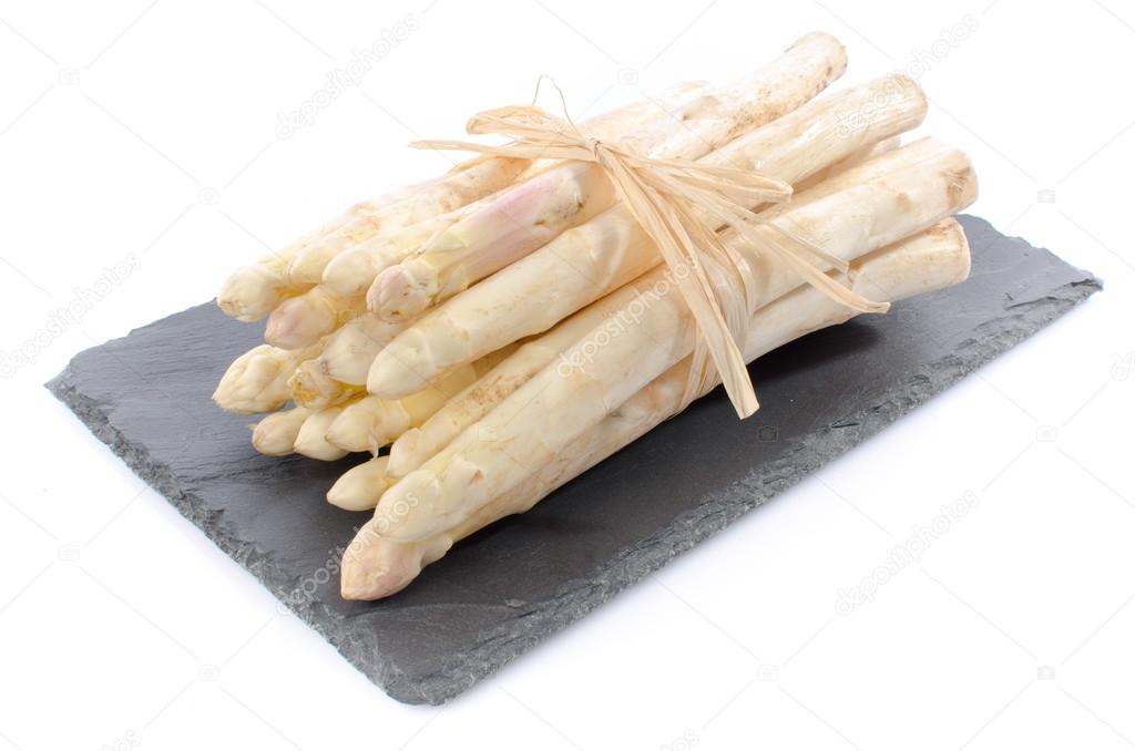 Bunch of fresh asparagus on a slate tray