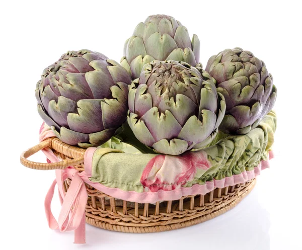 Fresh green purple artichokes in a basket — Stock Photo, Image