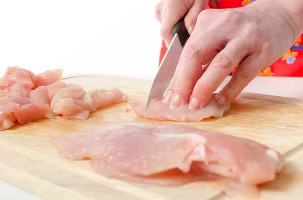 Hands of woman cutting meat — Stock Photo, Image