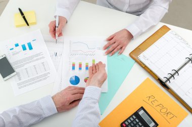 Business team working on financial graphs