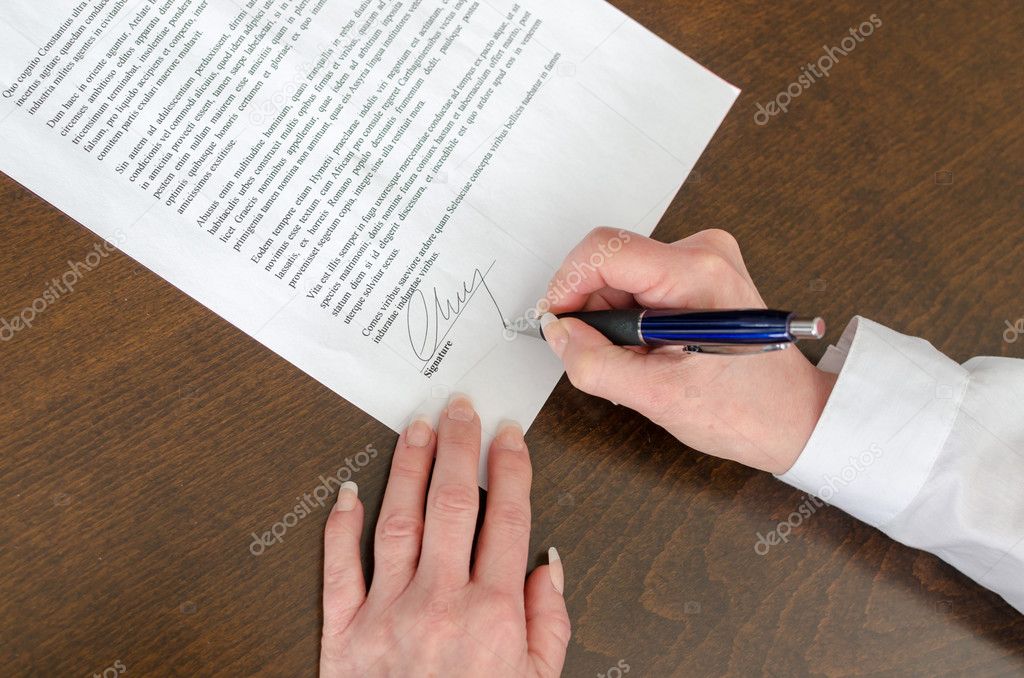 Businesswoman signing a document