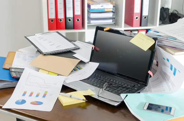 Untidy and cluttered desk — Stock Photo, Image