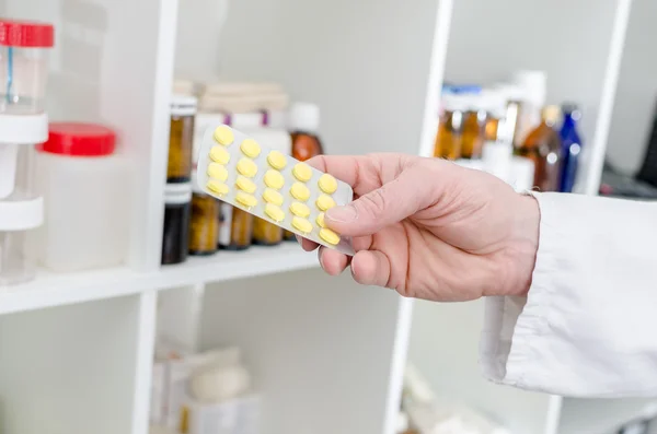 Hand holding a blister of pills — Stock Photo, Image