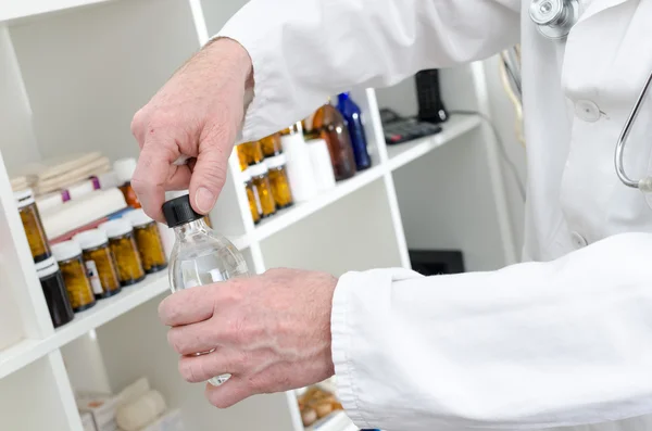 Doctor opening a bottle of disinfectant — Stock Photo, Image