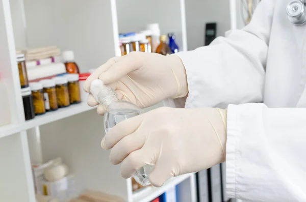 Doctor putting disinfectant on a piece of cotton — Stock Photo, Image