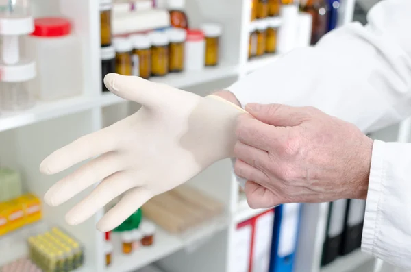 Doctor putting on a latex glove — Stock Photo, Image