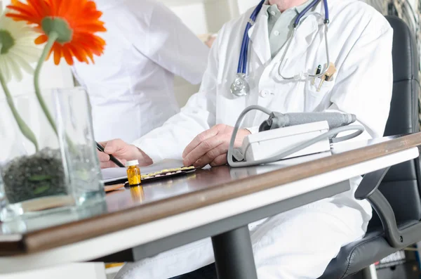 Doutor em sua mesa no consultório médico — Fotografia de Stock