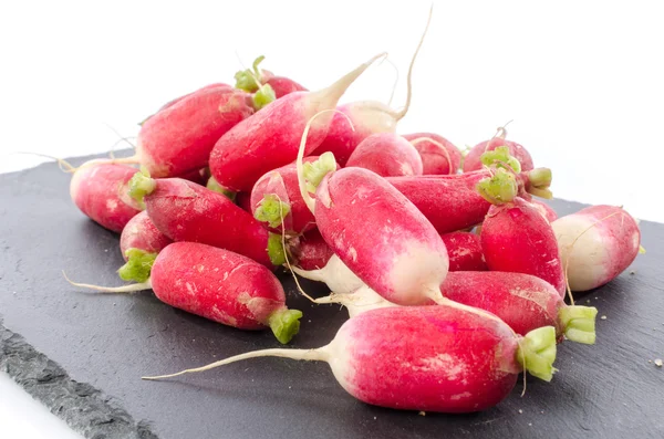 Fresh radishes on a slate plate — Stock Photo, Image