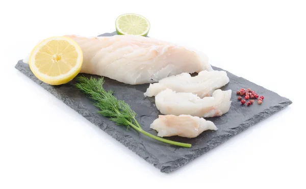 Fresh raw cod fillet on a slate plate — Stock Photo, Image
