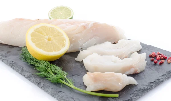 Fresh raw cod fillet on a slate plate — Stock Photo, Image