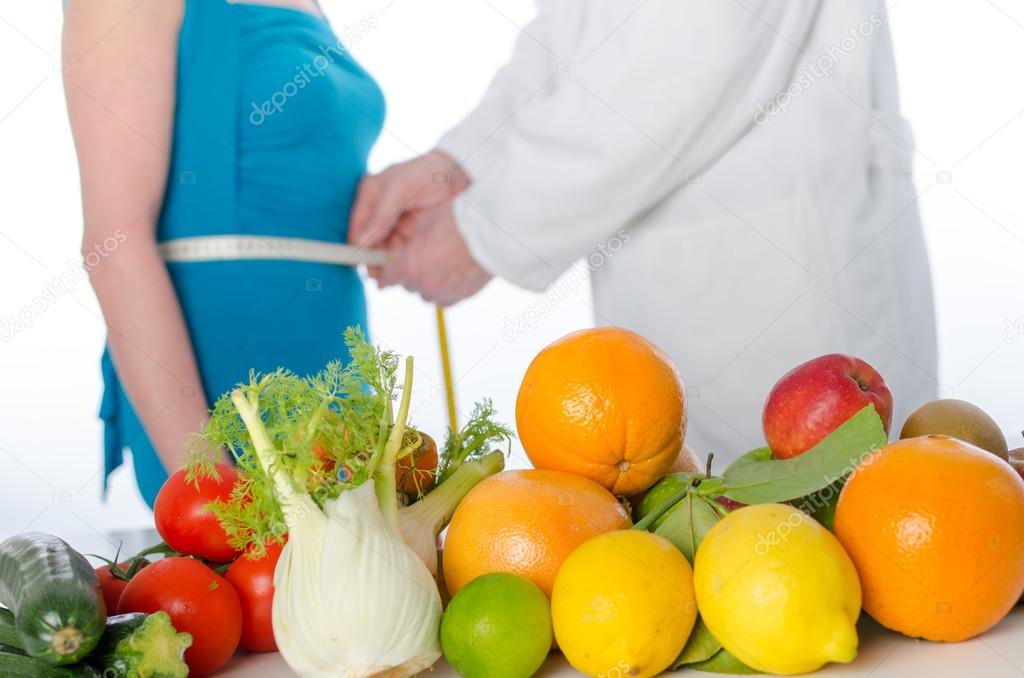 Doctor nutritionist measuring the waist of a patient