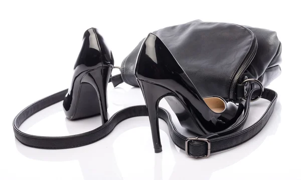Black high heels shoes with a black handbag — Stock Photo, Image