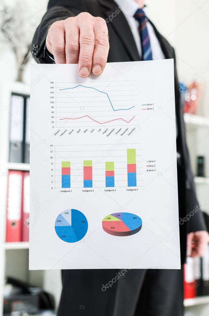 Businessman showing charts and graphics