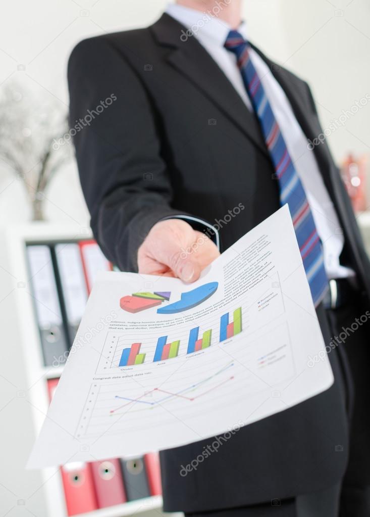 Businessman showing charts and graphics