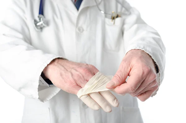 Doctor removing latex gloves — Stock Photo, Image
