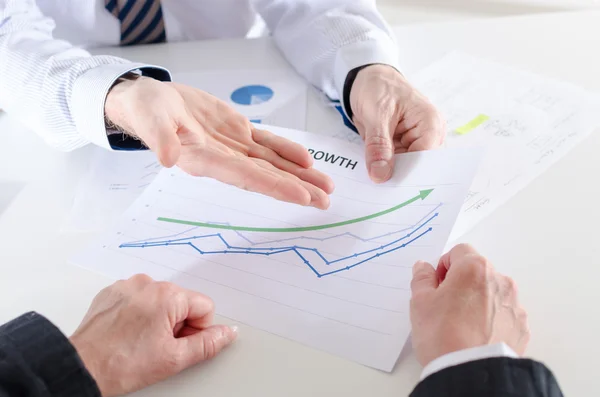 Businessman showing a financial graph Stock Picture