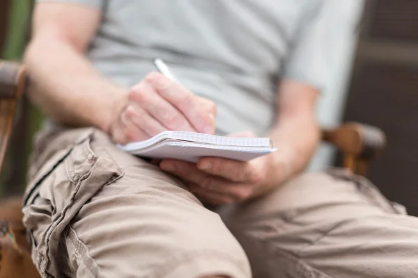 Man taking notes on a pocket book — Stock Photo, Image