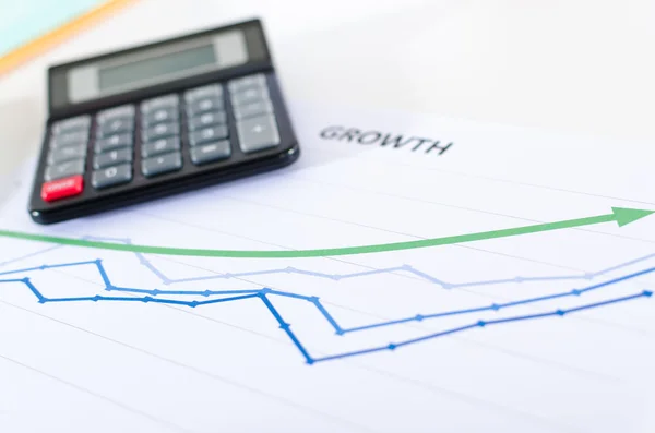 Financial graphs showing growth with calculator — Stock Photo, Image