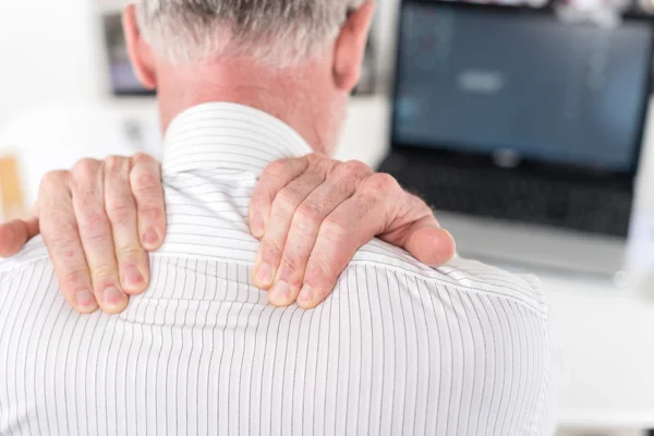 Businessman suffering from neck pain — Stock Photo, Image