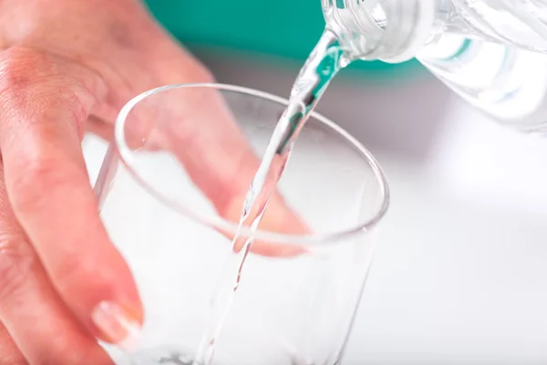 Pouring water into a glass — Stock Photo, Image