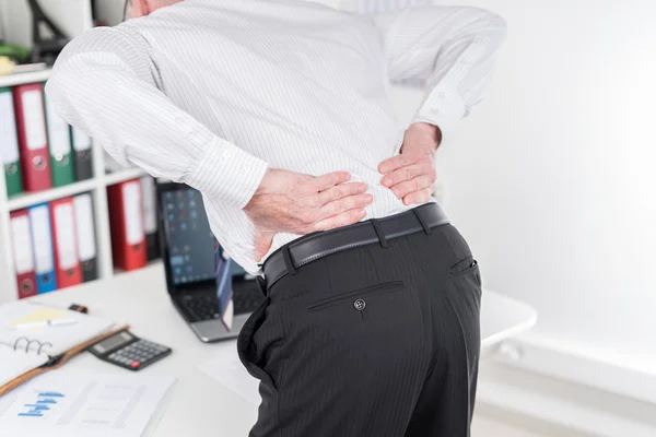 Businessman suffering from back pain Stock Image