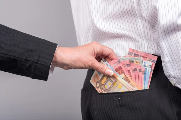 Vrouw die geld uit achterzak — Stockfoto