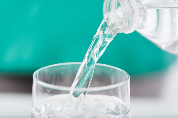 Pouring water into a glass — Stock Photo, Image