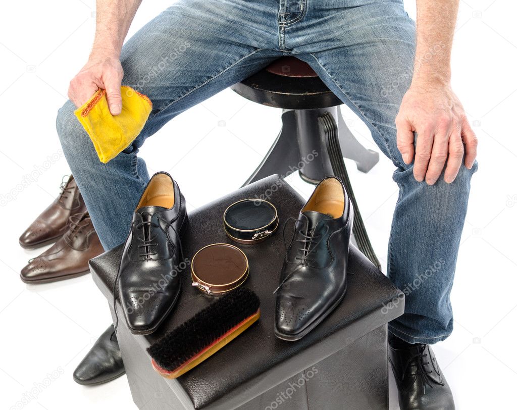 Shoe shiner in front of his equipment