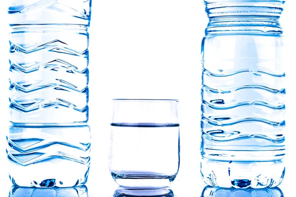 Plastic water bottles with a glass — Stock Photo, Image