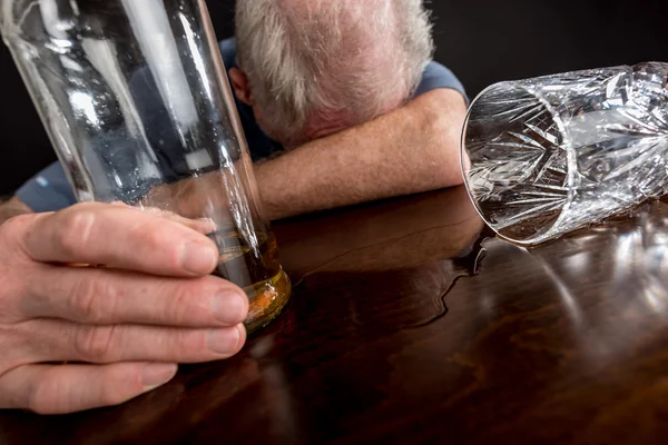 Drunk man slumped on table Stock Image