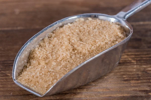 Brown sugar cane in a metal shovel — Stock Photo, Image